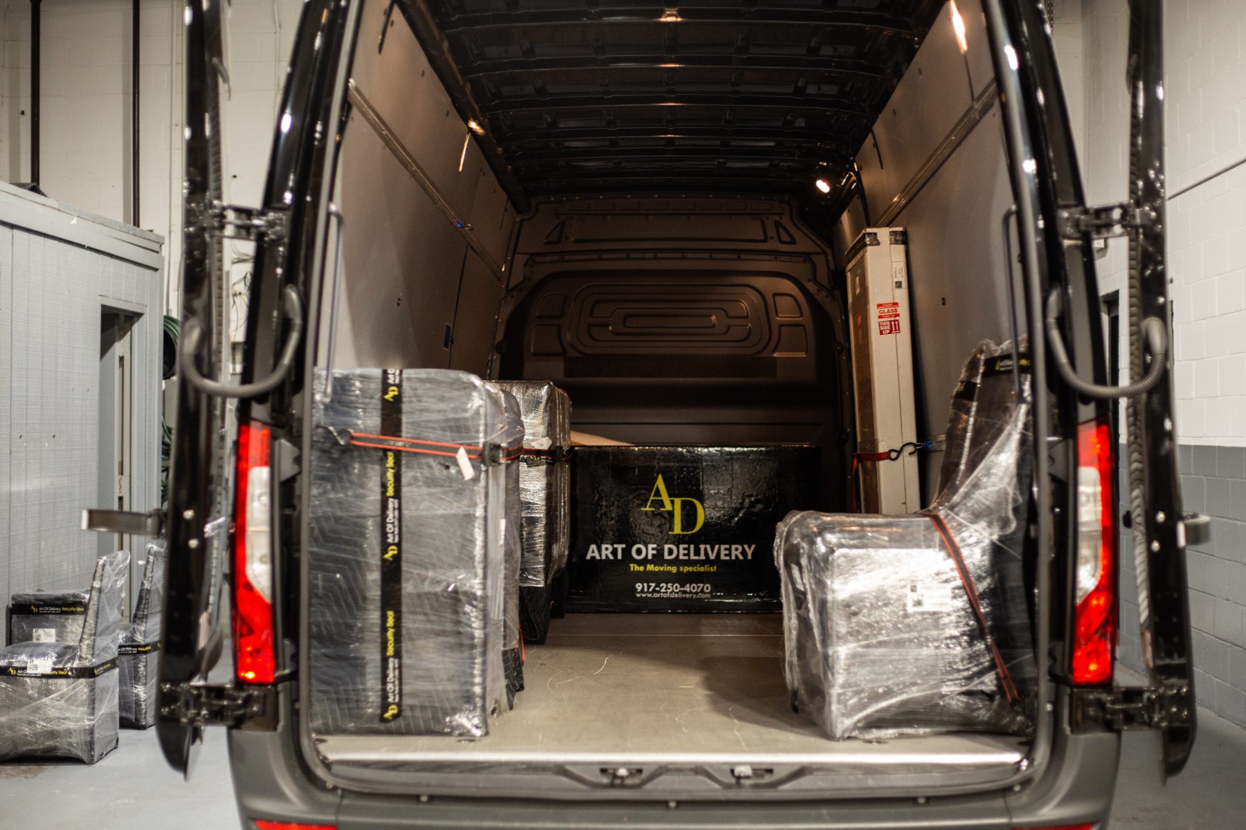 Loaded Art of Delivery van with wrapped pieces