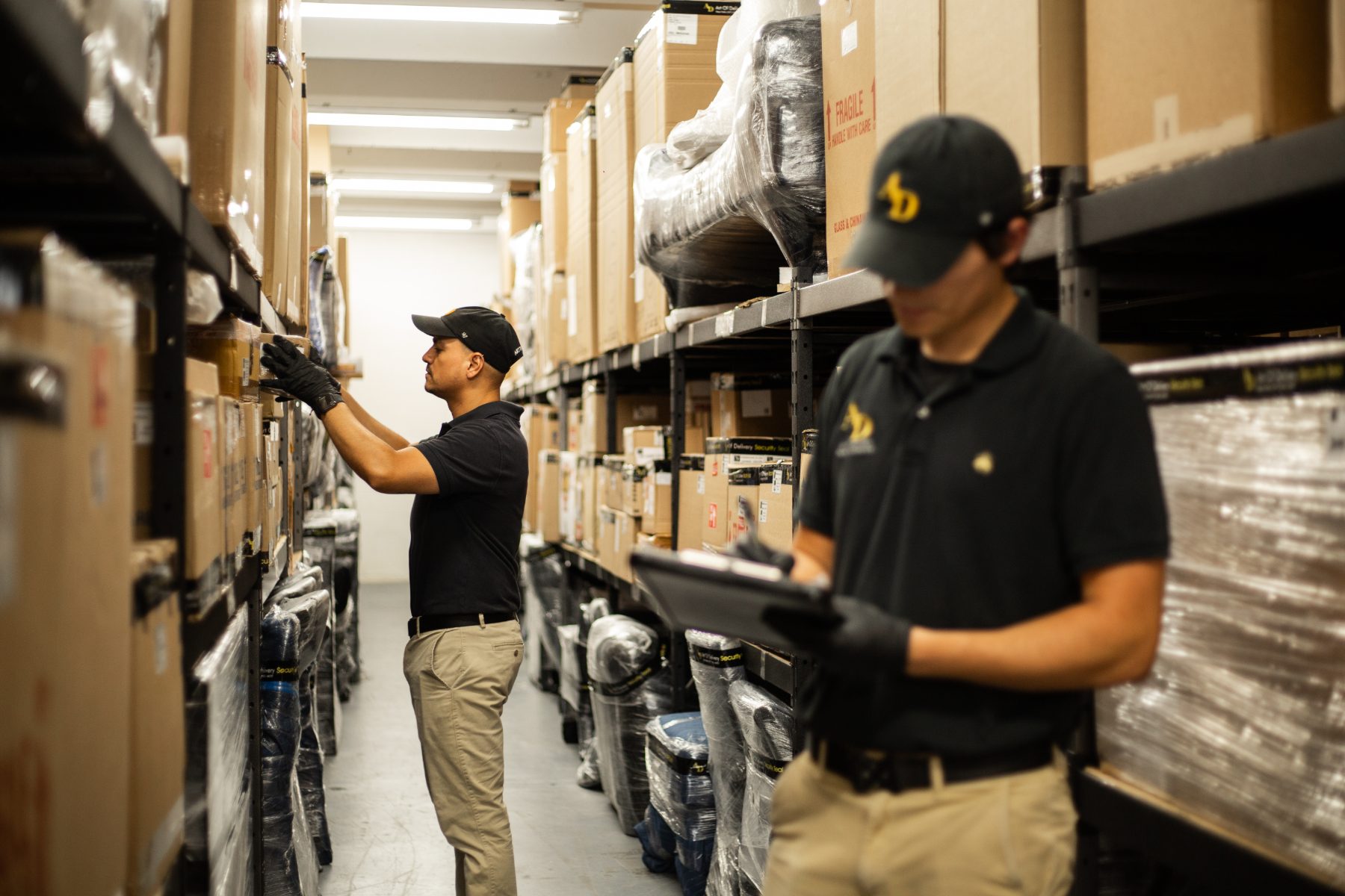 Art of Delivery crew checking inventory in the warehouse