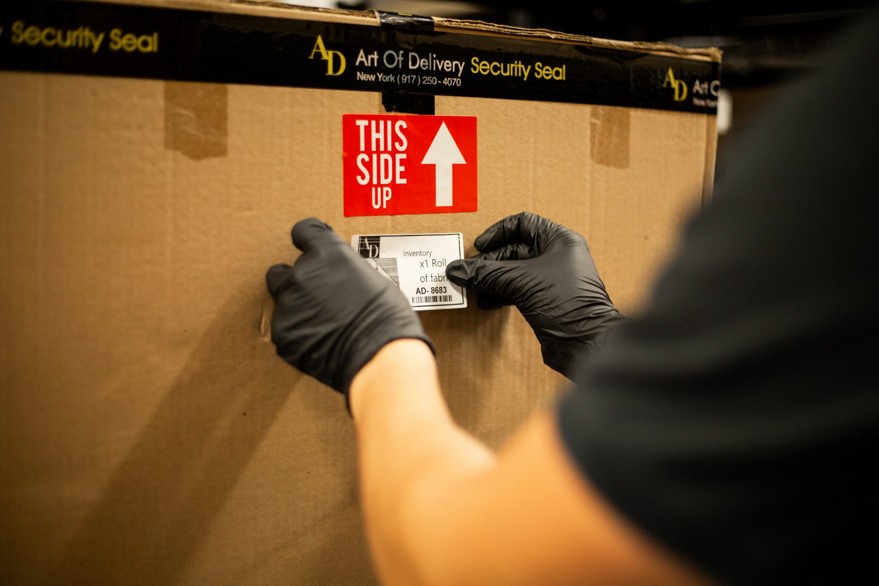 Applying a barcoded inventory label to a stored crate