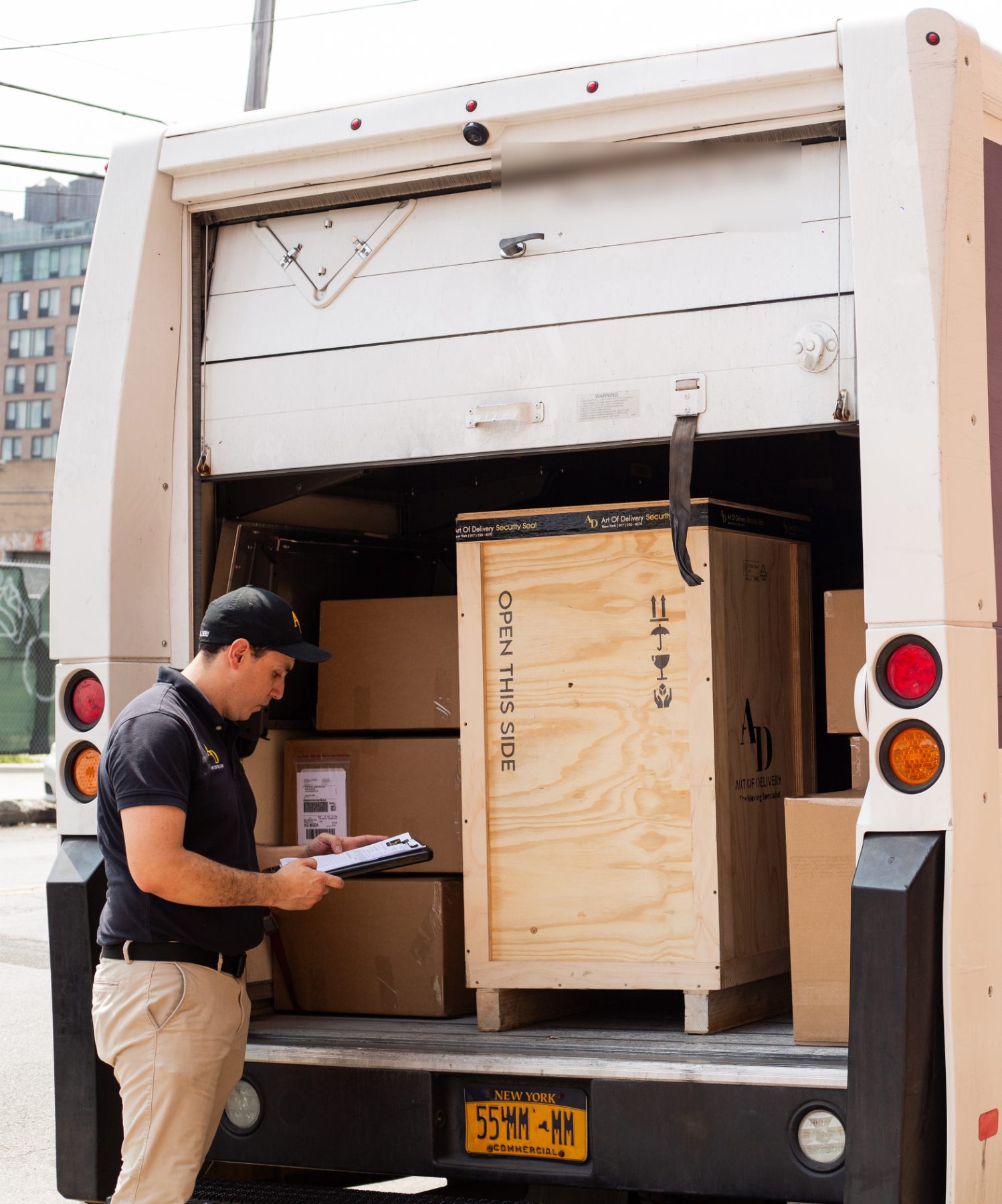 Art of Delivery crates loaded into a courier van for outbound shipping