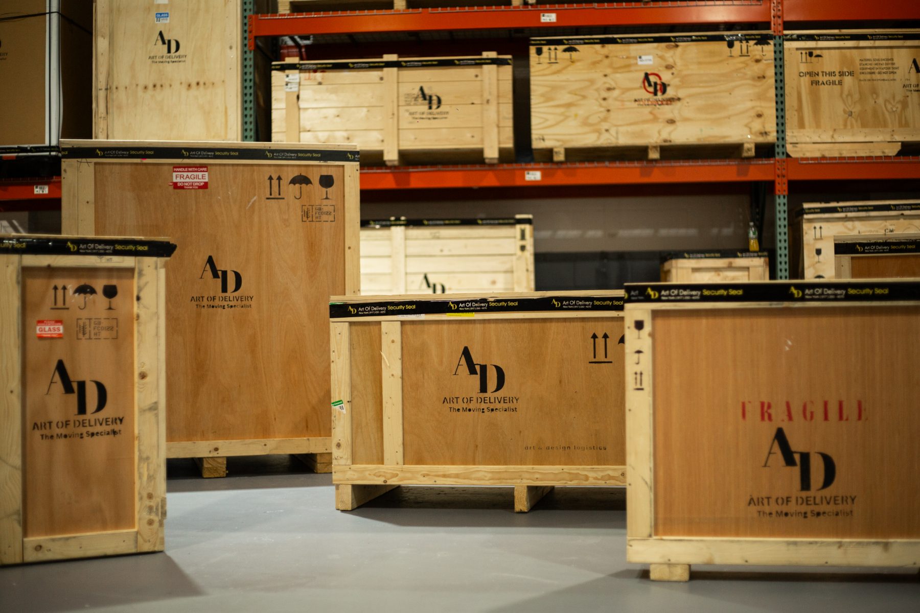 Branded Art of Delivery crates staged in the warehouse